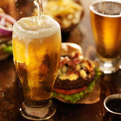 Tap beer glass and bacon cheeseburger served at Big Cherry Brewing Company restaurant, brewery and bar located in Big Stone Gap, VA logo